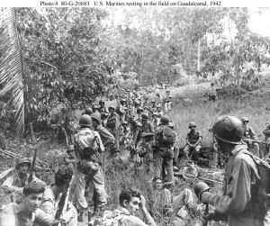 U.S. Marines resting in a field on Guadalcanal, 1942. Photo credit US Navy. 