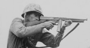 A WWII soldier fires a Thompson sub-machine gun.